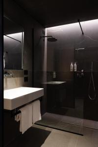 a bathroom with a white sink and a shower at Conterraneo Hotel in Marcianise