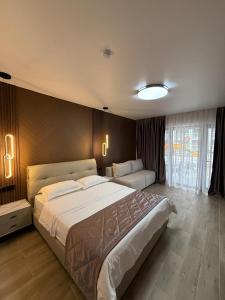 a large bedroom with two beds in a room at Na More Центр Семейного Отдыха in Kapchagay