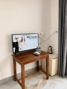 a flat screen tv sitting on top of a wooden table at Garden Hostel Koh Rong in Koh Rong Island