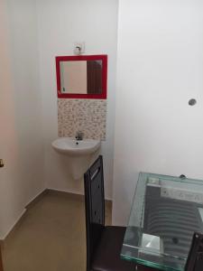 a bathroom with a sink and a glass table at Sheelas stay in Guruvāyūr