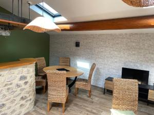 a dining room with a table and chairs and a fireplace at Le petit chalet in Luc-en-Diois