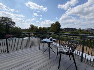 a patio with two chairs and a table on a deck at Niederrhein Suite Kerken in Kerken