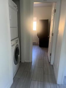 a laundry room with a washer and dryer on a tile floor at 3 bedroom 2 bathroom garden suite in Victoria