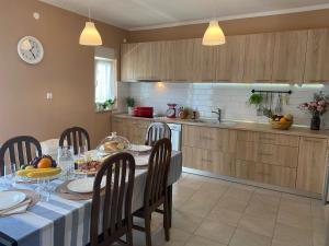 a kitchen with a table and chairs and a dining room at Private Villa Bonaventura with Pool & Jacuzzi & BBQ for Families & Groups near Split in Donja Mala