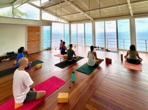 a group of people sitting in a room doing yoga at Acantilado Acapulco in Acapulco