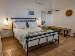 a bedroom with a bed and a table with towels on it at Sugarstone House in Adamantas