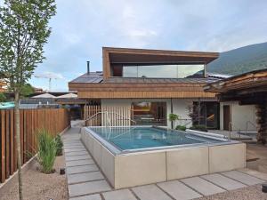a house with a swimming pool in the backyard at Appartements Else in Ortisei
