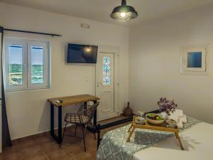 a living room with a table and a chair at Sugarstone House in Adamantas