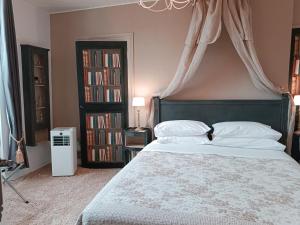a bedroom with a bed with a canopy and bookcases at Maison Nº 20 in Eymet