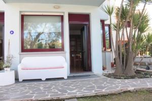 a white couch sitting outside of a house at Appartamento Stella Marina in Marcelli