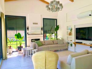 a living room with a couch and a chandelier at Villa Ada Bohème in Muğla