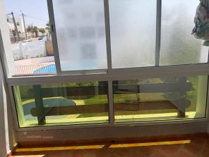 a window with a view of a patio at Blu capri in Dar Bouazza +5 photos