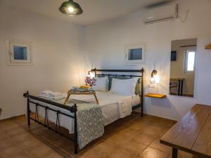 a bedroom with a bed and a table at Sugarstone House in Adamantas