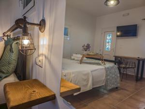 a room with a bed and a table and a window at Sugarstone House in Adamantas