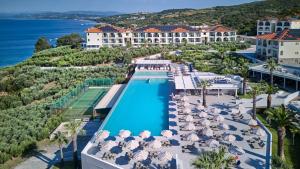 an aerial view of the resort with a swimming pool and the ocean at Akrathos Beach Hotel in Ouranoupoli