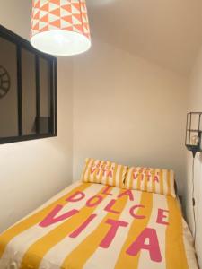 a bedroom with a bed with a colorful comforter at Gilie beach in Saint-Brevin-les-Pins