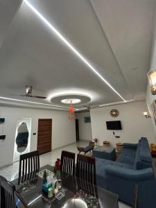 a living room with a couch and a table at Chic & Modern Getaway with Designer Interiors in Jaipur