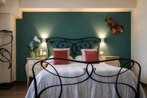 a bedroom with a bed with a green wall at Il Castellaccio in Spello