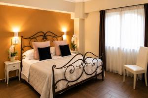 a bedroom with a large bed and a window at Il Castellaccio in Spello +87 photos