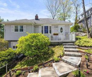 a white house with stairs in front of it at Gilded Age Luxury Surrounded by Nature in Norwalk