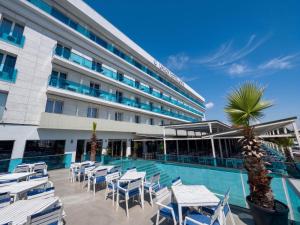 ein Hotel mit Pool und Liegestühlen und einem Gebäude in der Unterkunft Hotel Union in Eforie Nord