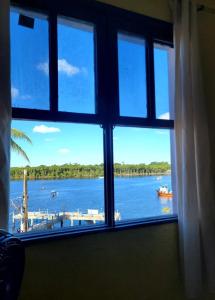 a window with a view of a body of water at Pousada Nova Onda in Paranaguá