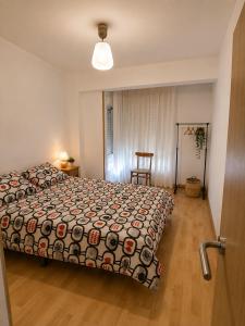 a bedroom with a bed and a table and a chair at Apt Puerto Burriana in Burriana
