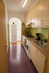a kitchen with a white refrigerator and a sink at Apt Puerto Burriana in Burriana