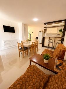 a living room with a table and a dining room at cottage in tsemi (Borjomi) in Borjomi