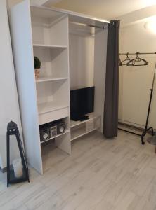a living room with a tv and a white closet at Casa Doris in Montabone