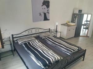 a bedroom with a bed with a striped blanket at Casa Doris in Montabone