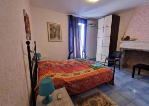 a bedroom with a bed and a fireplace at B e B- Il casale del melograno-Country House in Piano di Santa Laura