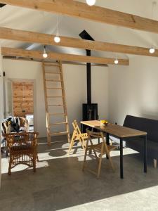 a room with a table and chairs and a ladder at Homin riky in Myta