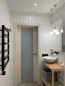 a bathroom with a white sink and a door at Homin riky in Myta +32 photos