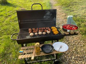 a grill with meatballs and vegetables on a table at Homin riky in Myta