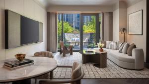 a living room with a couch and a table at Kimpton Nine Trees Shanghai by IHG in Shanghai