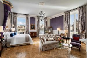 a bedroom with a bed and a couch and a chandelier at The St. Regis Florence in Florence