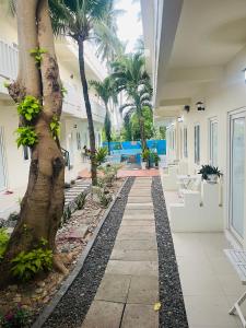 a hallway of a house with a tree at La Mer Mũi Né Hotel in Ấp Thiện Long