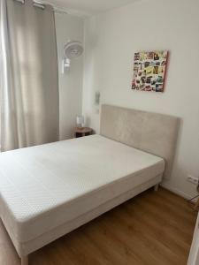 a bedroom with a bed with a white mattress at Villa de l Eyre in Salles