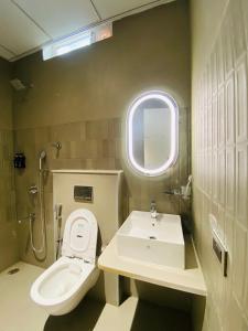 a bathroom with a toilet and a sink at Hotel Radhe Imperial in Hyderabad +52 photos