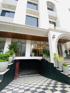 a building with potted plants on the side of it at Hotel Radhe Imperial in Hyderabad