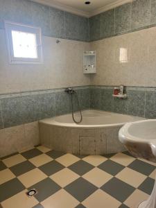 a bathroom with a tub and a sink at La villa jasmin in Al Maqārisah +70 photos