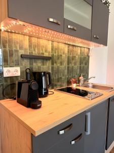 a kitchen with a counter top with a coffee maker on it at Apartments Chloe - Top 4 in Hollabrunn