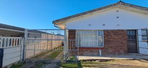 a brick house with a fence in front of it at Kuils River Apartment, near Cape Town Airport in Sarepta