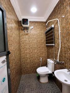a bathroom with a toilet and a sink at Layiz Court in Lagos +15 photos