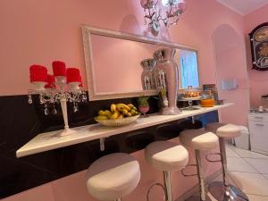 a bathroom with a counter with stools and a mirror at Le Palme Di Como in Como