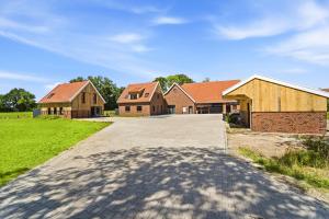 eine Gruppe von Häusern mit einer Auffahrt in der Unterkunft Neu! Auszeit an der "Grenzfarm" - Stilvolle und geräumige FeWo - perfekt für Radfahrer und Familien in Nordhorn