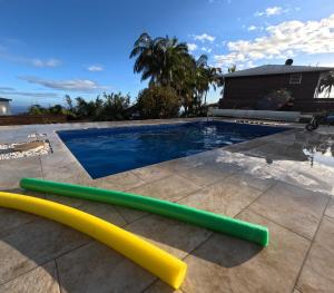 a pool with two inflatable paddles on a patio at Chez Marie Line in Saint-Joseph