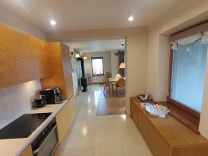 a kitchen with a large window and a living room at Secret Residence with Sauna & Private Pool in Kościelisko