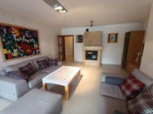 a living room with a couch and a coffee table at Secret Residence with Sauna & Private Pool in Kościelisko